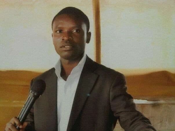 Pastor Tare Godfrey speaking into a microphone